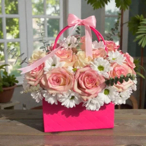 Blush pink rose bloom box with white daisies, eucalyptus greenery, and ribbon handle