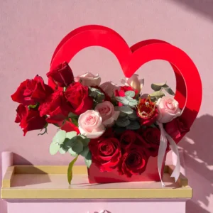 Heart-shaped rose basket with red and pink roses and decorative handle