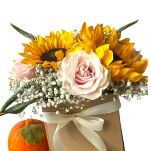 Golden Blush sunflower box with bright yellow sunflowers, blush pink rose, baby’s breath, and ivory ribbon