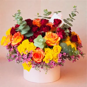 Sunset Harmony rose box with red, yellow, and orange roses arranged in a white hat box